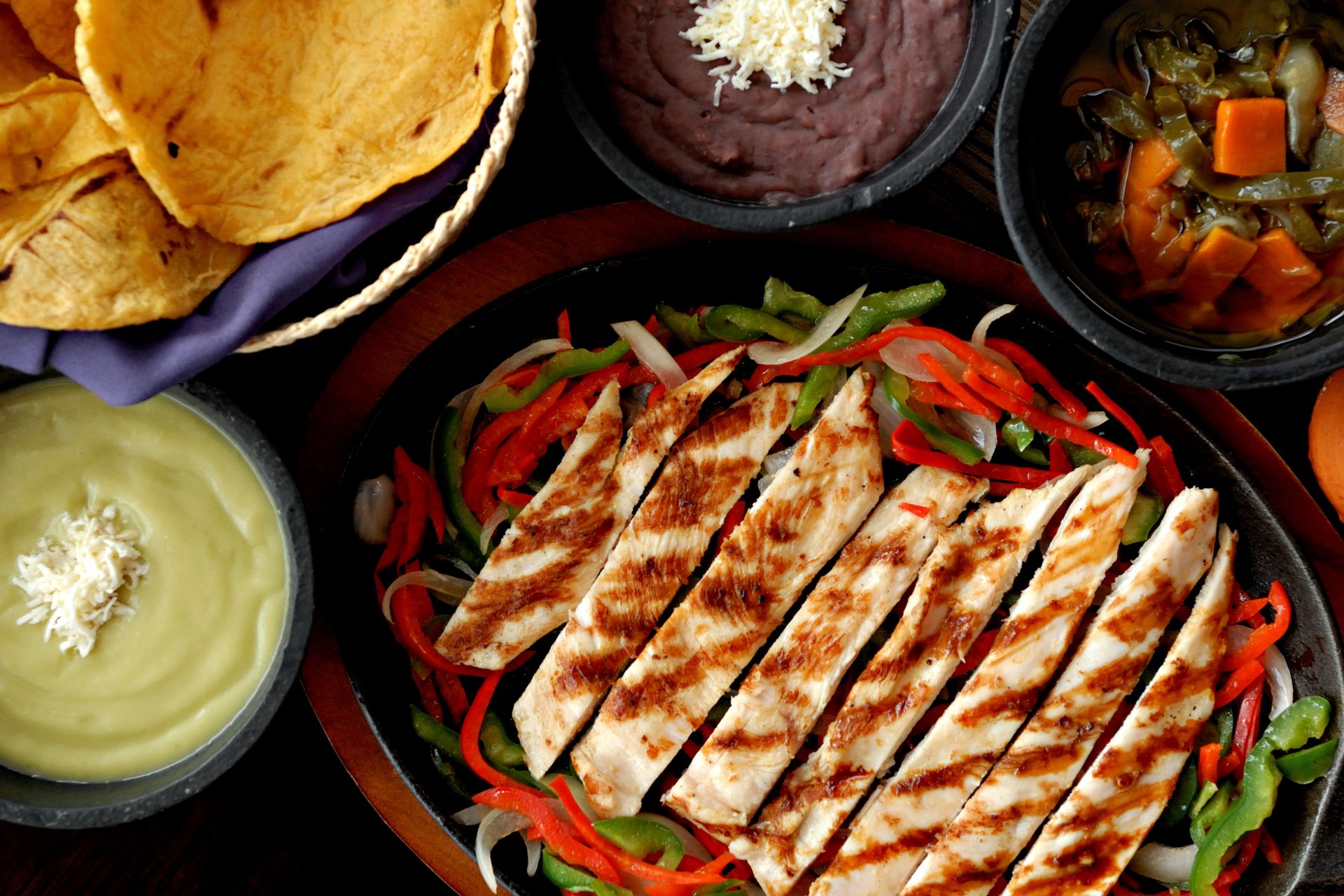 Delicious chicken fajitas with colorful peppers, tortillas, and traditional Mexican sides.